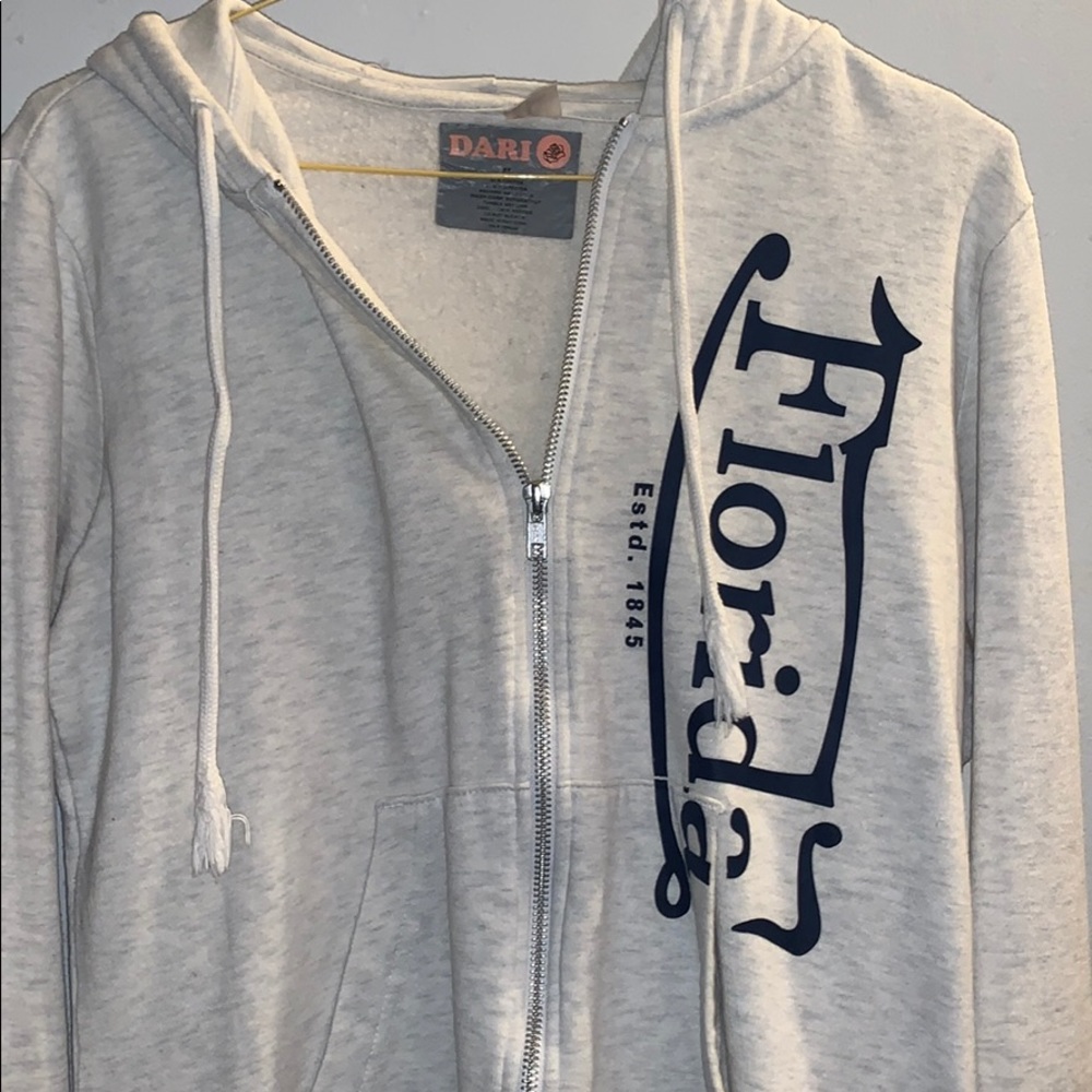 Tan zip up Sweater with Florida lettering on it